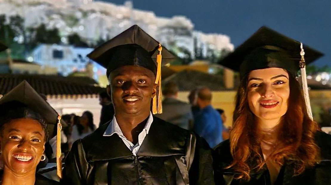 Webster University in Athens, Commencement 2024, professor and two students in front of Acropolis. 