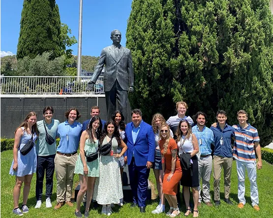 Webster Athens students are in the US Embassy of Athens and pose for a photo with the Ambassador 