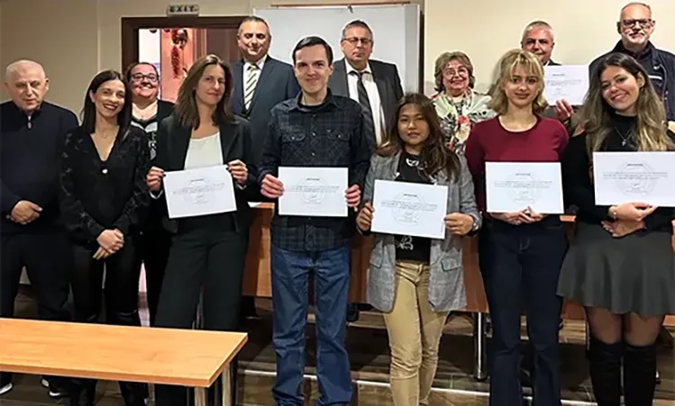 students posing for a photo with their certificates 