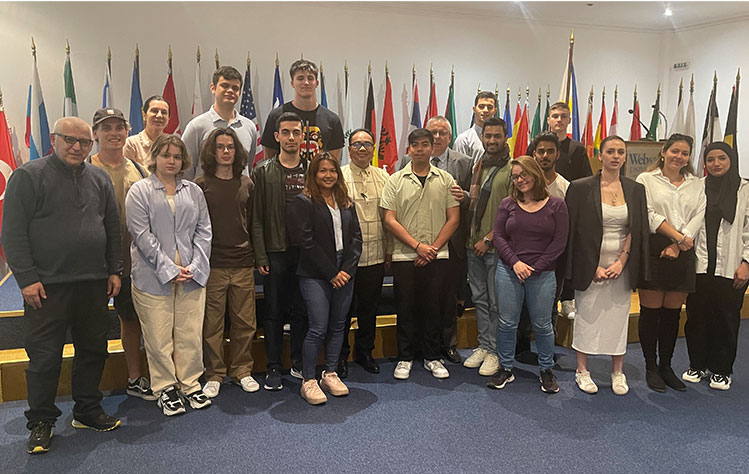 Ambassador of the Philippines to Greece, Giovanni E. Palec (center), poses for a commemorative photo with students from Webster Athens after delivering his lecture.