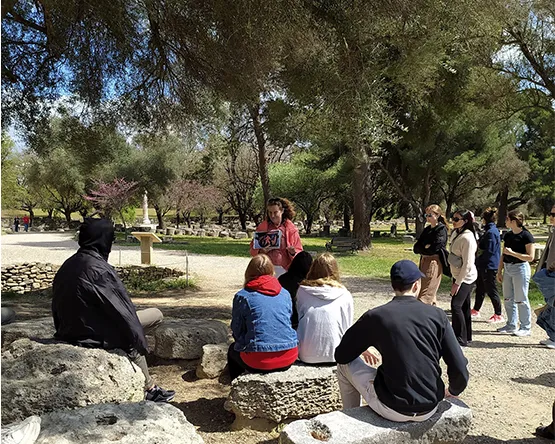 students learning about ancient olympia standing in the historic field